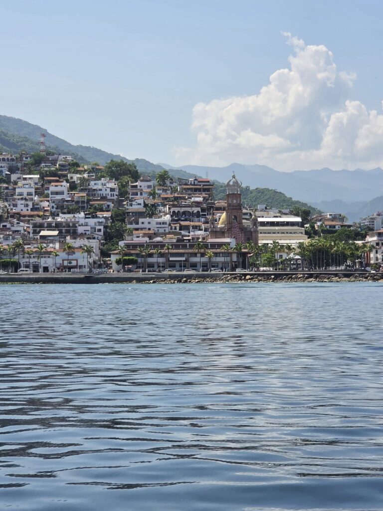Scenic view of Puerto Vallarta coastline with the Church of Our Lady of Guadalupe and mountains in the background