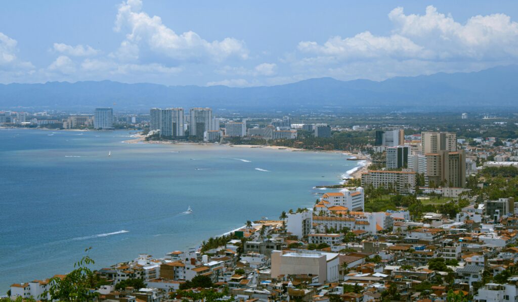 Aerial view of Puerto Vallarta coastline and 5 de Diciembre neighborhood with ocean and high-rise buildings