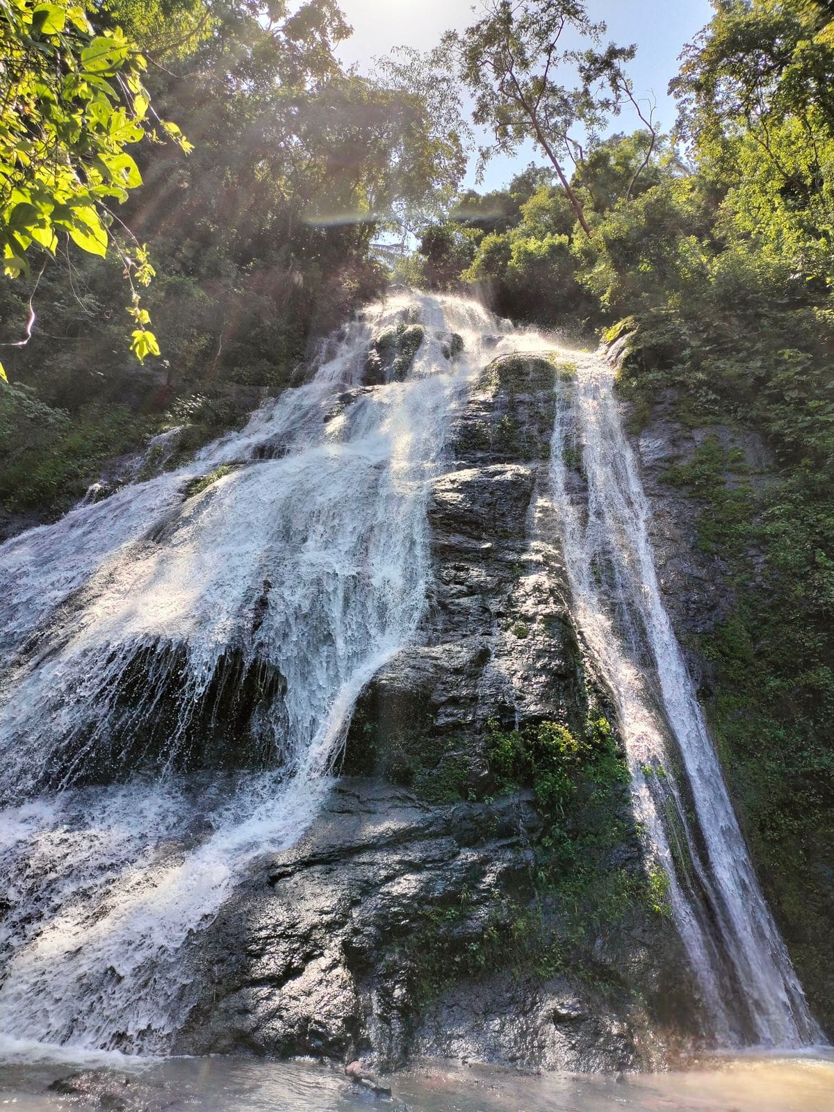Hidden jungle waterfall near Puerto Vallarta surrounded by lush tropical forest in the Sierra Madre mountains