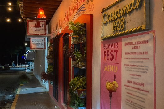 Warmly lit exterior of a traditional Mexican café in Puerto Vallarta at night