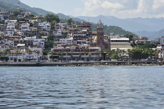 Scenic view of Puerto Vallarta coastline with the Church of Our Lady of Guadalupe and mountains in the background