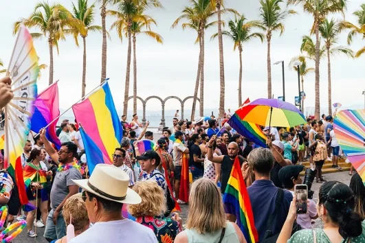 "Vibrant Puerto Vallarta Gay Pride parade celebrating LGBT tourism and inclusivity."
