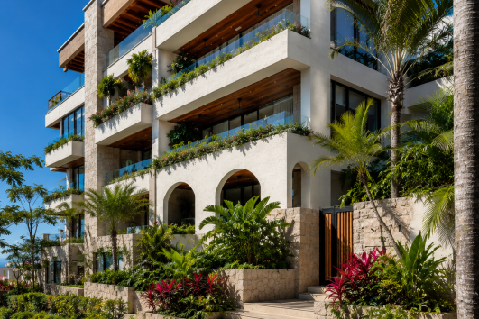 Luxury boutique condominium development in Puerto Vallarta with modern architecture, spacious balconies, and tropical landscaping
