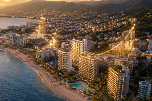 Aerial view of Puerto Vallarta beachfront condos with glowing real estate growth graphs showing property appreciation trends at sunset.