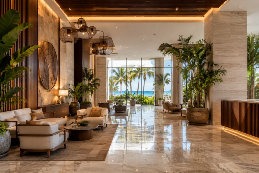 Luxury condominium lobby in Puerto Vallarta with ocean views, modern Mexican design, marble floors, tropical plants, and upscale seating.