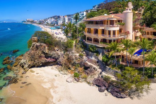 A luxurious beachfront villa in Mexico’s Restricted Zone, showcasing ocean views and modern architecture, ideal for foreign buyers