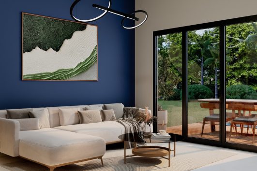 Modern coastal-inspired living room with large glass doors, natural light, contemporary furniture, and indoor-outdoor design