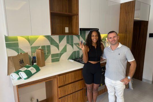 Real estate agent handing over keys to a happy client at Vrede, a presale condo in Puerto Vallarta.