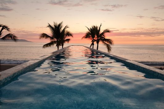 Beachfront condo pool at sunset in Puerto Vallarta – ideal for presale buyers