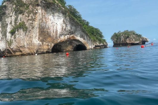 Scenic view of Los Arcos rock formations in Puerto Vallarta with clear blue ocean and sky