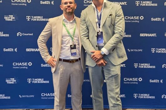 Two real estate professionals networking at a real estate conference in Puerto Vallarta