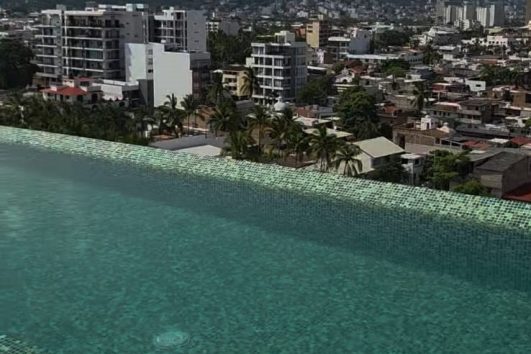 Rooftop infinity pool overlooking Versalles Puerto Vallarta real estate investment area