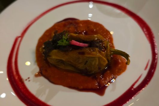 Gourmet fine dining dish served in an upscale restaurant, illustrating gastronomy's influence on neighborhood appeal and real estate appreciation