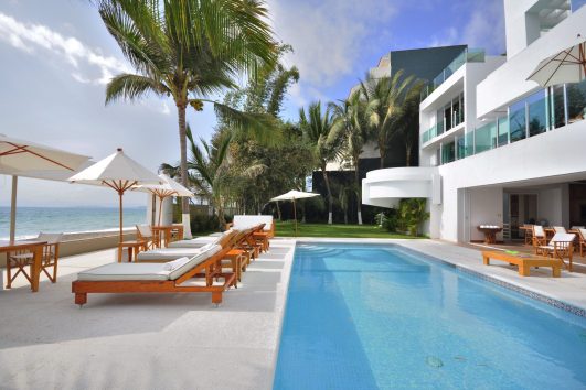 Beachfront luxury home in Puerto Vallarta with a pool and ocean view, creating a relaxed and secure ambiance.