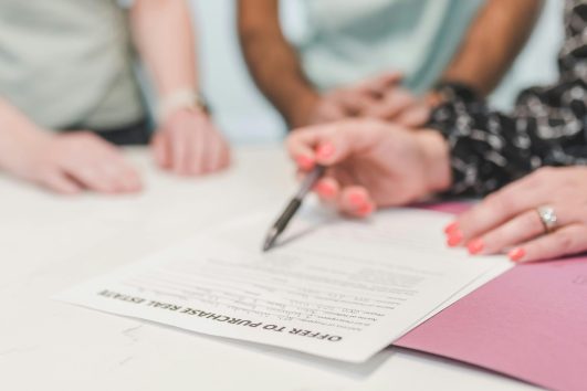 Foreign buyers signing Fideicomiso trust for Puerto Vallarta real estate purchase